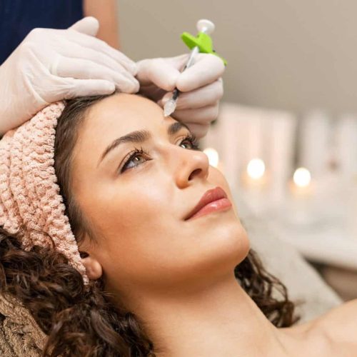 Woman getting anti age filler in clinic