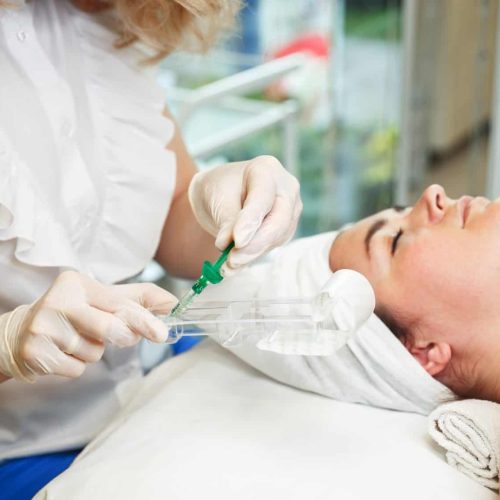Woman getting treatment with injectable hyaluronic acid dermal filler